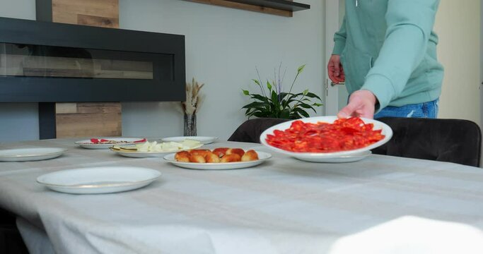 guy setting the table at home for a speciald ay with his family