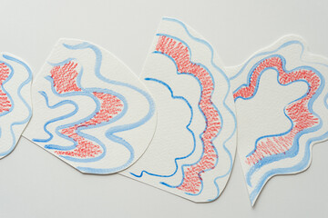 somewhat overlapping fan-like paper shapes with wavy blue lines and red shading effect on paper