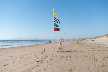 Beach on Costa da Caparica in Portugal, Atlantic Ocean coast. Unrecognisable people on the beach....