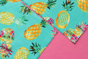 two zigzag trim fabric sheets with pineapple prints on pink paper