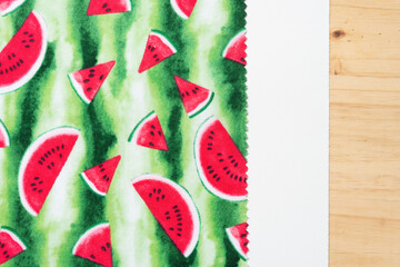 watermelon print fabric square with zig zag edge on paper and wood