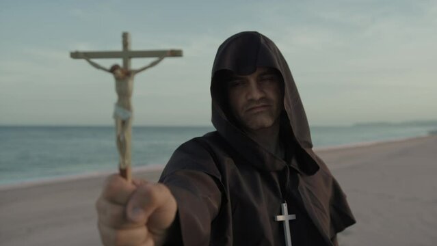 Monk With Statuette Of Jesus In His Hand Prays