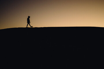 silhouette of a person in the mountains