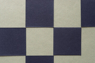 Fototapeta premium checkered background with black paper tiles on green
