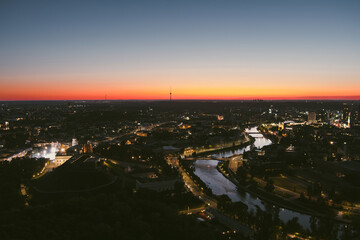 Scenic aerial view of Vilnius Old Town and Neris river at nightfall. Sunset landscape.