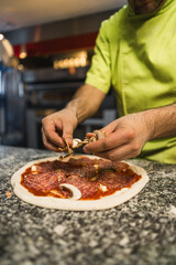 closeup shot of a man cook preparing pizza, italian cuisine and food concept. High quality photo