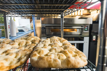 baking impala pizza dough in an oven, bakery kitchen. High quality photo