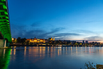 evening view of the Warsaw embankment in Poland and the royal palace