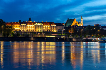evening view of the Warsaw embankment in Poland and the royal palace