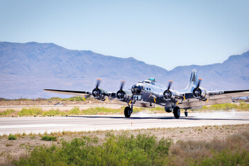 A four engine World War Two era heavy bomber lands at a New Mexico airport.