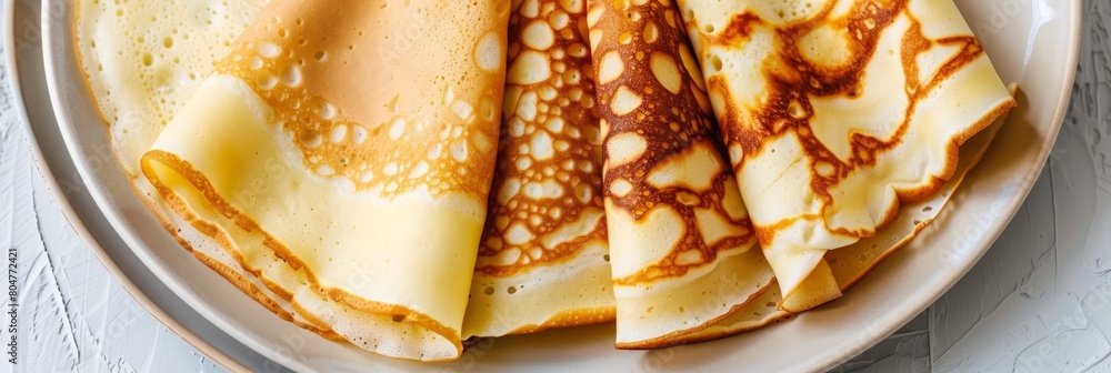 Poster top view of rolled pancakes on light or gray background with ample space for text placement