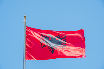The Albanian flag on a pole