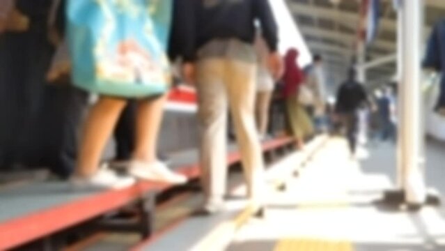 Cinematic shot. Passengers stepping out through the commuter train&rsquo;s automatic door. Modern public transport concept. Out of focus