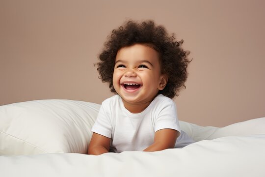 Joyful young child with curly hair laughing