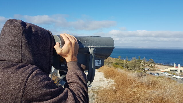 person looking through binoculars