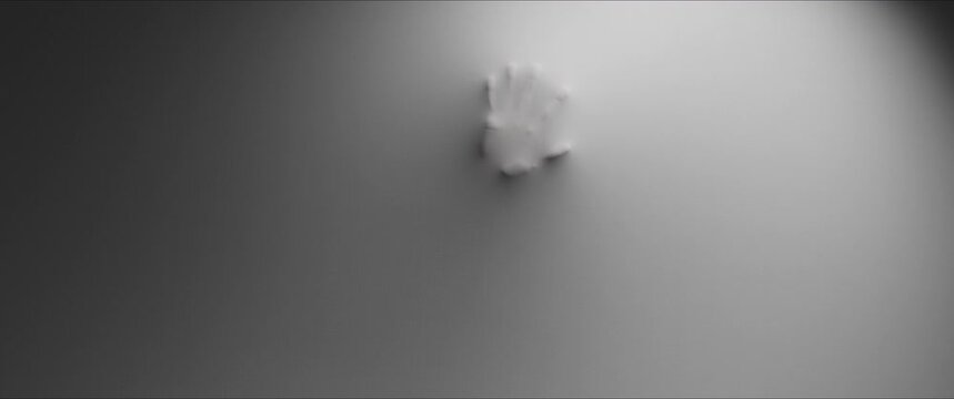 The shapes of the woman's hands push through the white wall