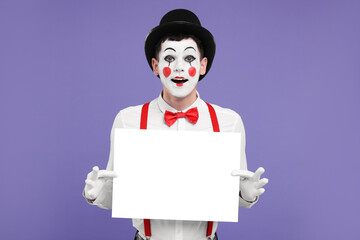 Funny mime artist with blank sign on purple background