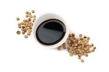 Tasty soy sauce in bowl and soybeans isolated on white, top view