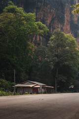 A lone shack surrounded by mountains.