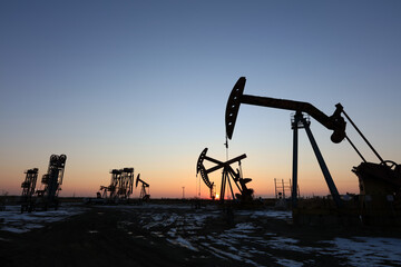 In the evening, oil pumps are running, Silhouette of beam pumping unit