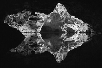 Fototapeta premium Black and white photo of the inside of a cave