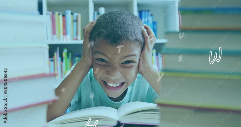 Aufkleber digital composition of multiple alphabets floating against boy covering his ears in library