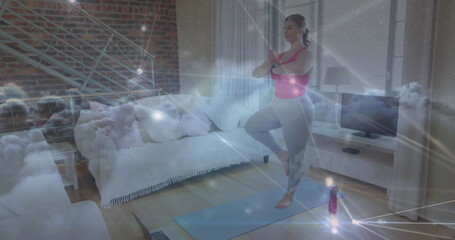 Image of network of connections over woman practicing yoga at home