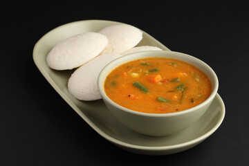 Idly sambar or Idli with Sambhar and green, red chutney. Popular South indian breakfast
