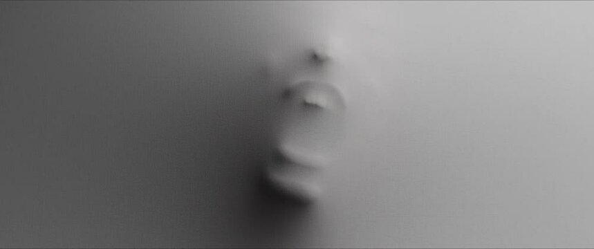 The shape of the woman's screaming face extrudes from the wall 