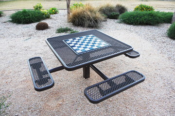 Metal mesh chess table with seats in a public park