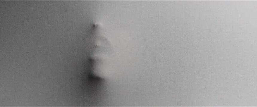 The shape of the woman's head extrudes from the wall 