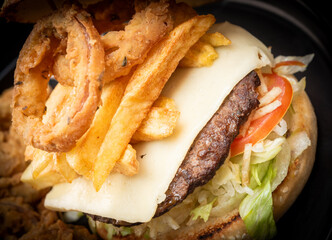 Cheese hamburgers sandwich with fried potatoes with black background, nice