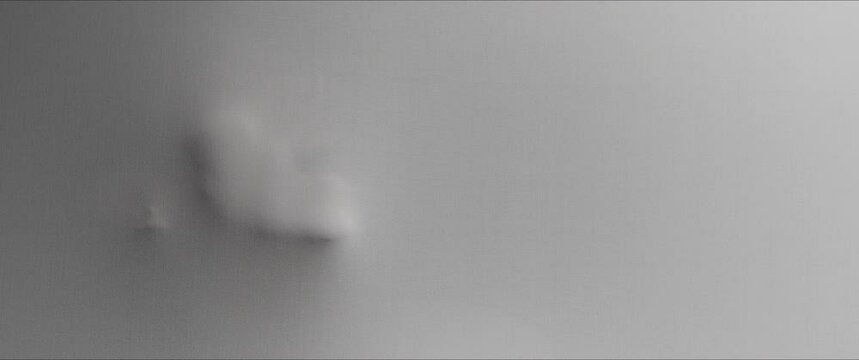 A scary woman's face extrudes from the wall surface