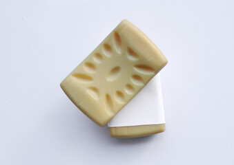 Yellow soap with blank label with color on gray background