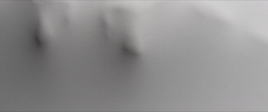 A woman's back extrudes from the wall surface