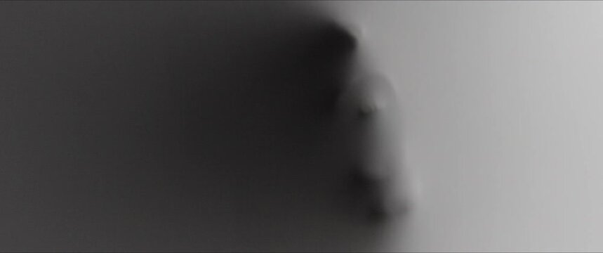 A scary face with teeth appears from the white surface