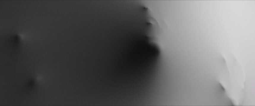 A  screaming woman's face and hands appear from the wall surface w