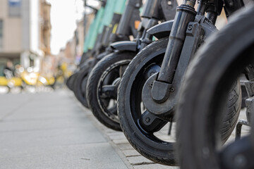 Close up of tires of electric scooters for rent in city