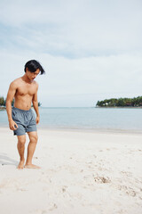 Muscular Asian Athlete Enjoying Beach Run: Capturing the Power and Freedom of an Active Lifestyle
