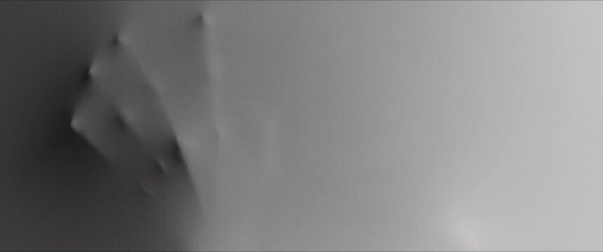 A woman hand and face extrudes from the wall surface