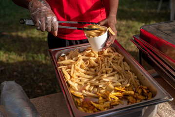 A person holding a bowl of Chips and fries served at a pop-up event in Lagos, Nigeria on April 13,...