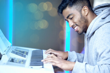 Indian man, music and happy with keyboard or instrument for skill practice, talent and passion. Musician, rehearsal and smile or satisfied with career growth, piano and confident for performance