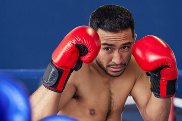 Man, athlete and fighting with gloves in ring for training, workout and practice for boxing...