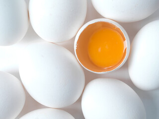 white chicken eggs on a white background, free range orange yolk