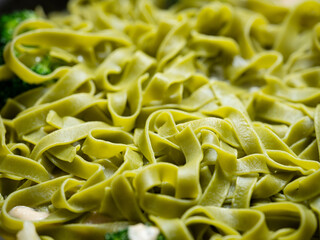 Spinach pasta boiling in a pot	