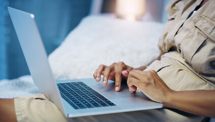 Person, laptop and hands in bedroom for streaming, online app or social media and internet for relax. Tech user and digital device indoor for typing, email or research for website, networking or blog