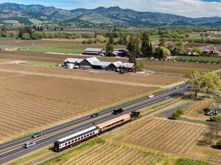 Napa Valley wine train alongside vineyards. Napa, California, United States of America.