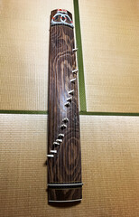 A Koto, a traditional 13 stringed instrument on the tatami mats of a Japanese-style room. The whole...