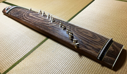A Koto, a traditional 13 stringed instrument on the tatami mats of a Japanese-style room. The whole...