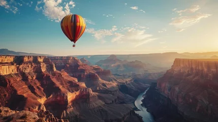 Fototapeten Hot air balloon floating over Grand Canyon with copy space area. © CHAWA GEN